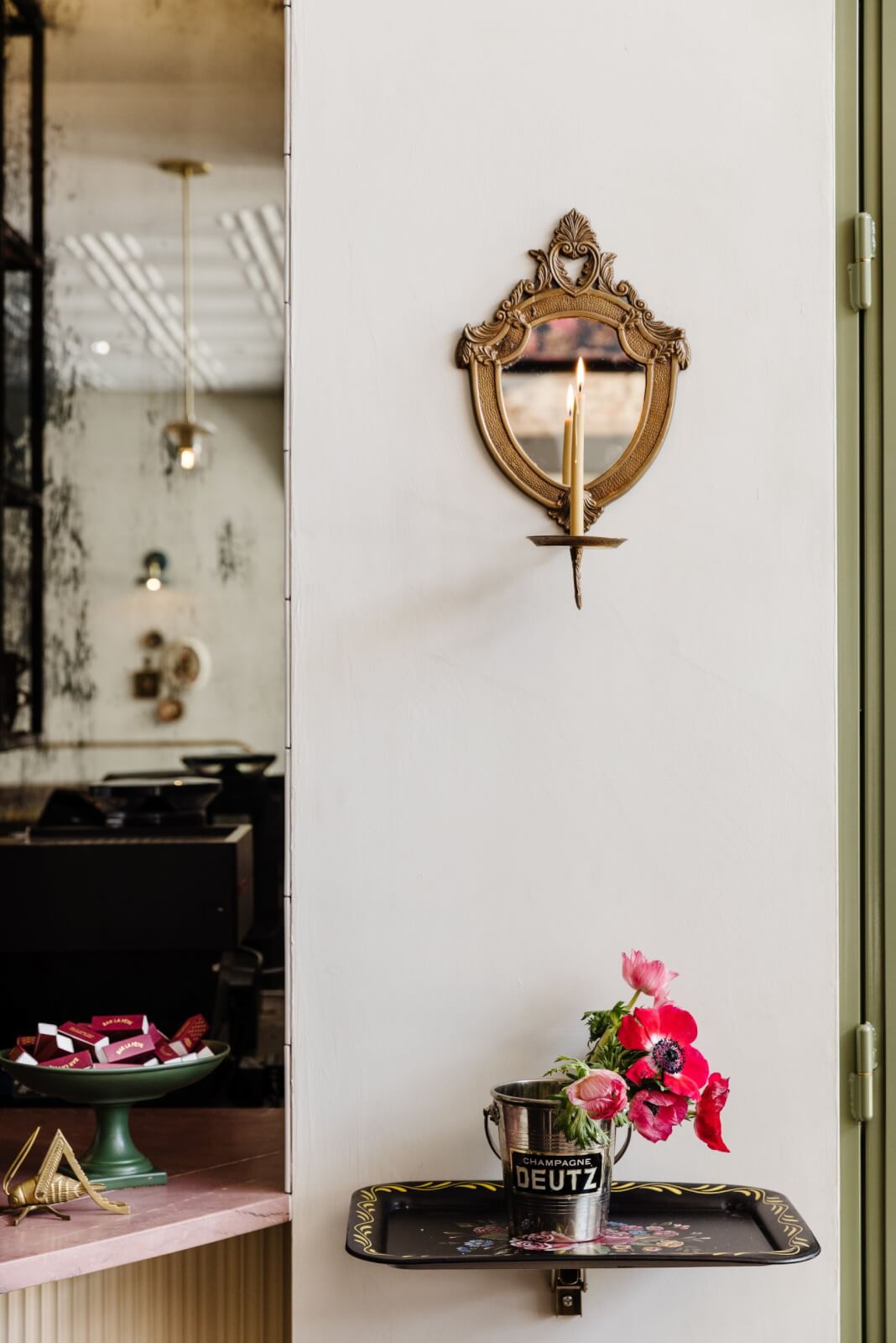 Close-up of candle sconce lighting and florals