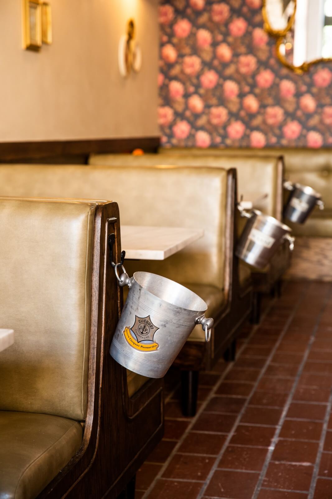 Close-up of Clicquot wine buckets hanging on booths at Bar la Fete in Birmingham, AL
