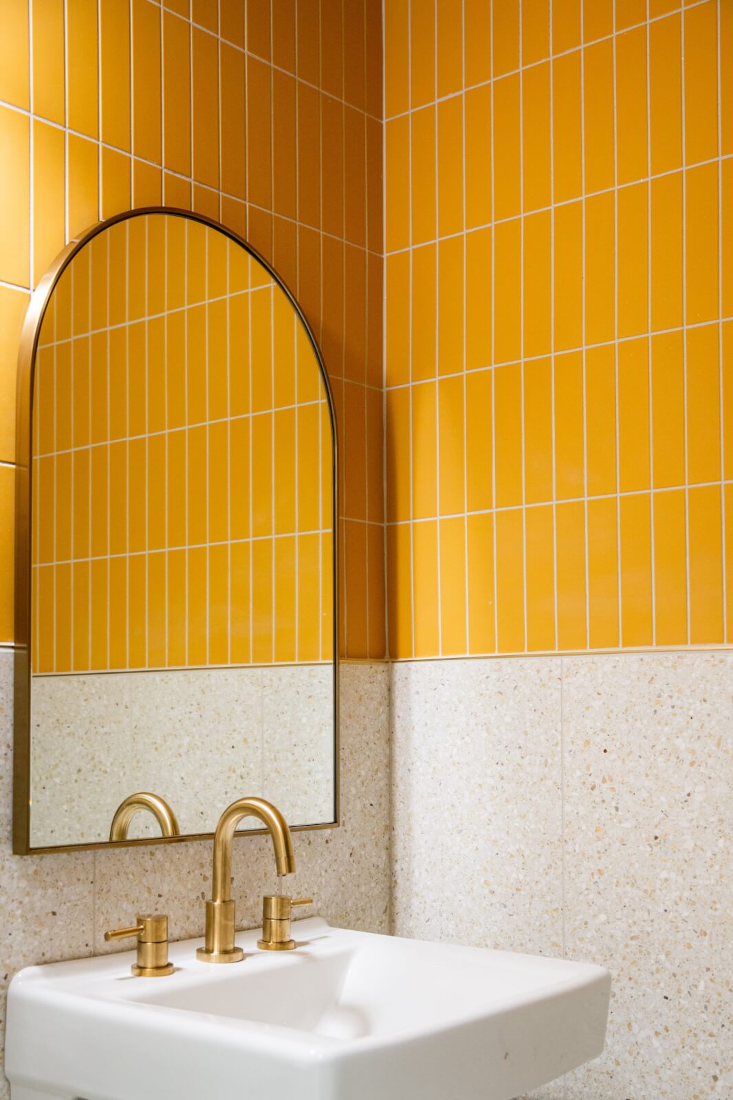 Yellow bathroom at Bar la Fete in Birmingham, AL