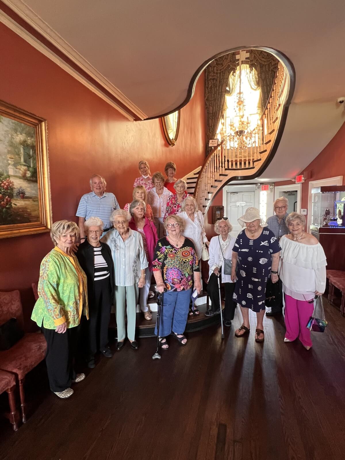 A group of residents standing by the stair at The Saint Paul, an independent senior living community in Nashville, TN.