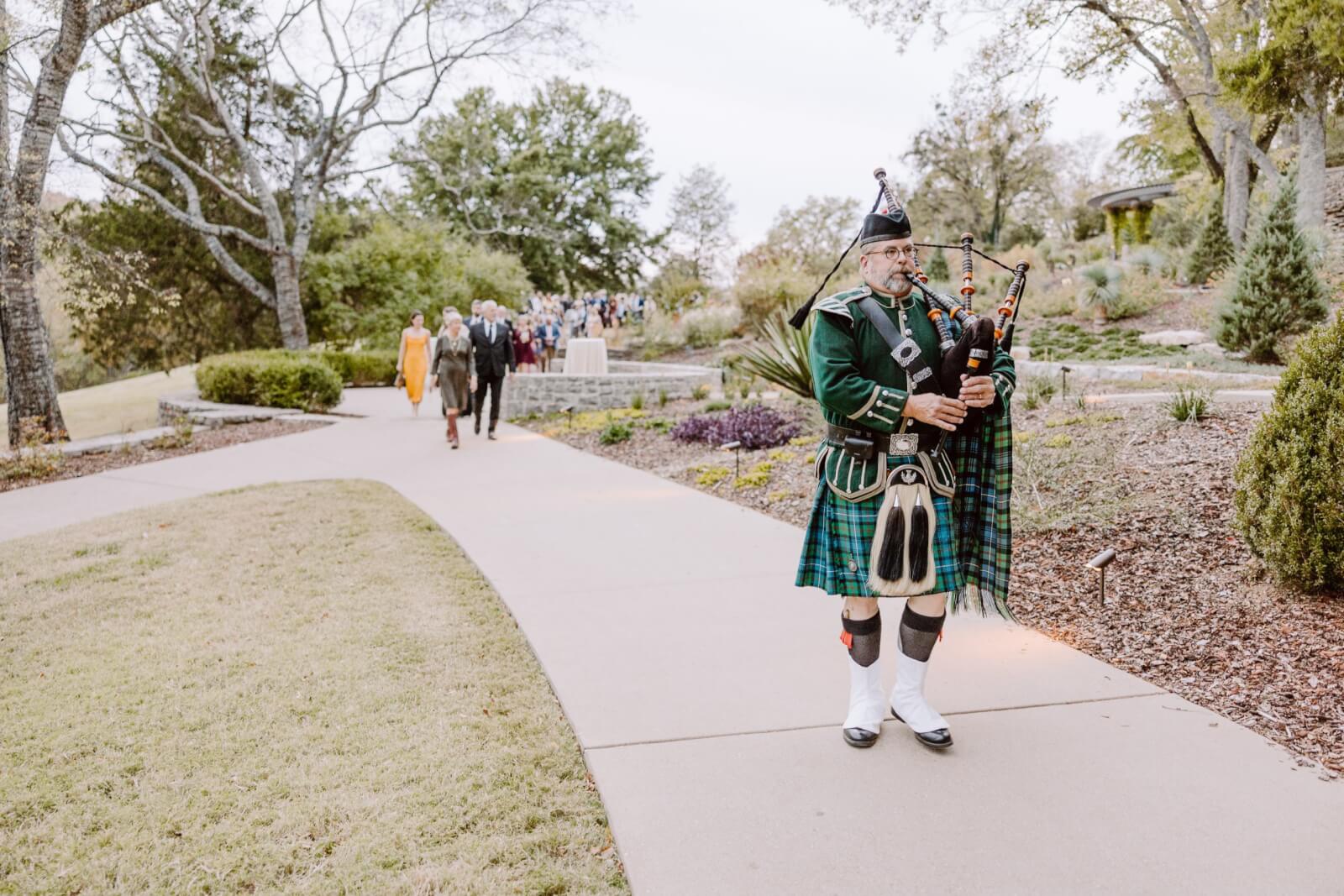 A surprise bagpiper leads the bridal party to the reception.