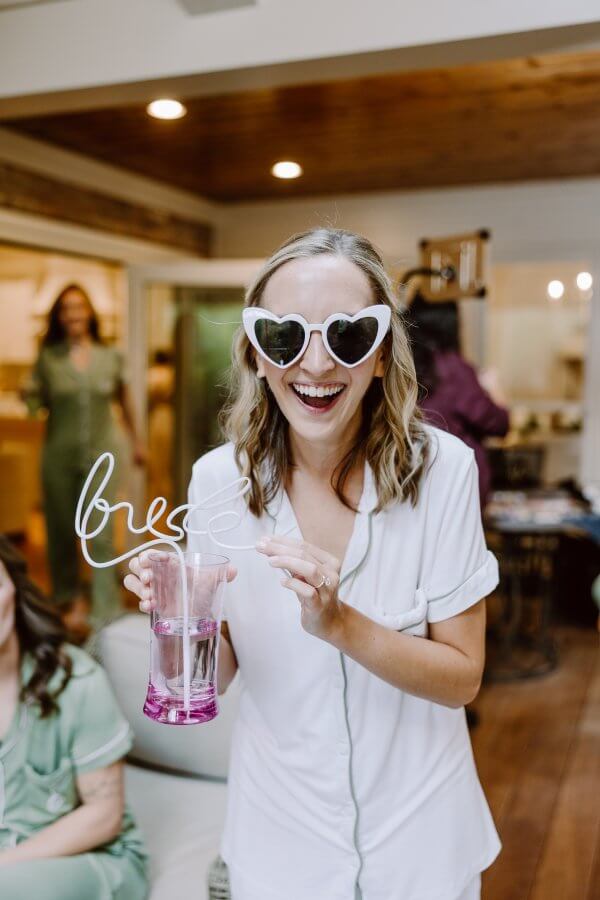 Bride Blythe Cate wears heart sunglasses as she gets ready to wed.