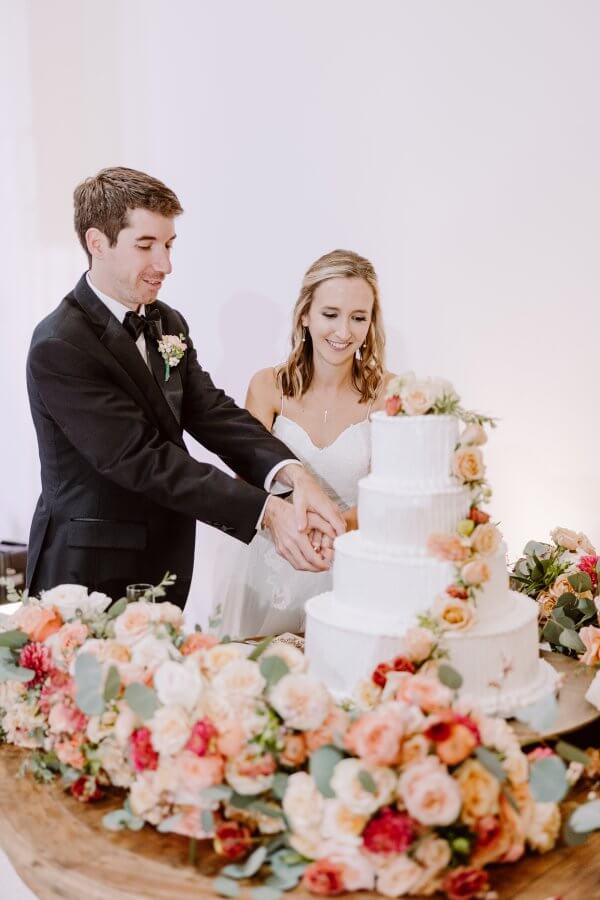 The bride and groom cut the cake.