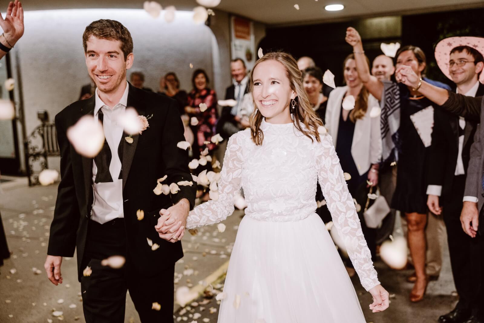 The bride and groom leave the Cheekwood wedding reception to rose petals.