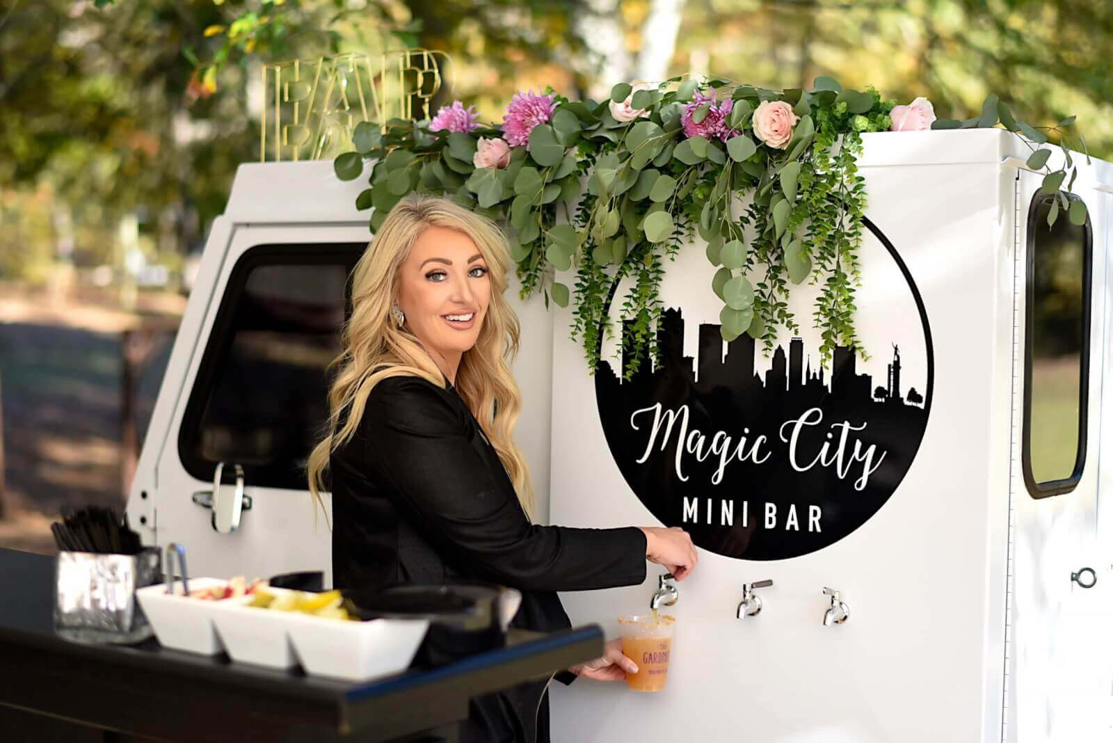 Tiffiany Ward smiling in front of Magic City Mini Bar truck