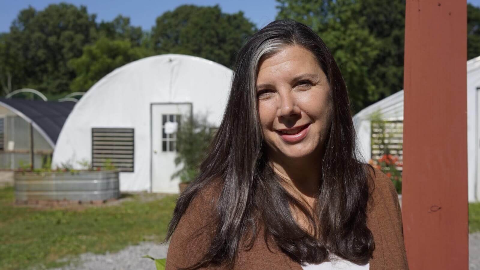 Melonie Lusk smiling at farm