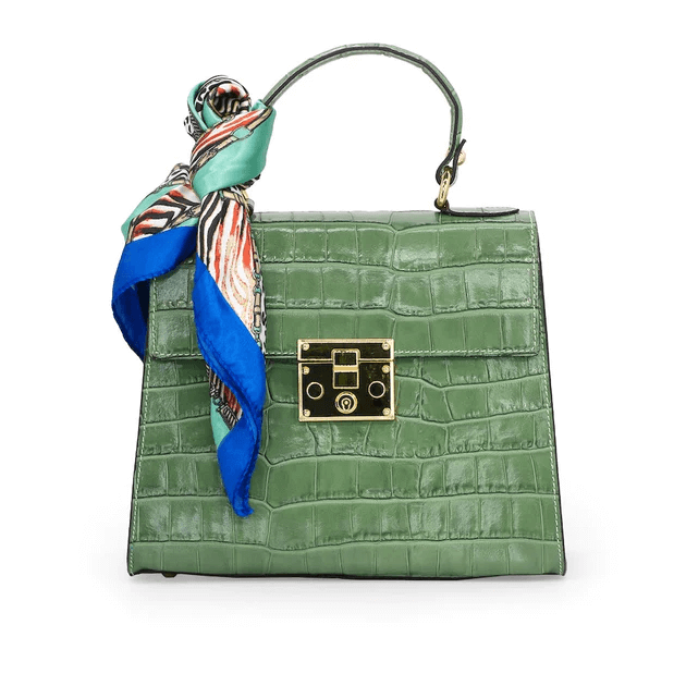 Green handbag with silk scarf tied around the handle.