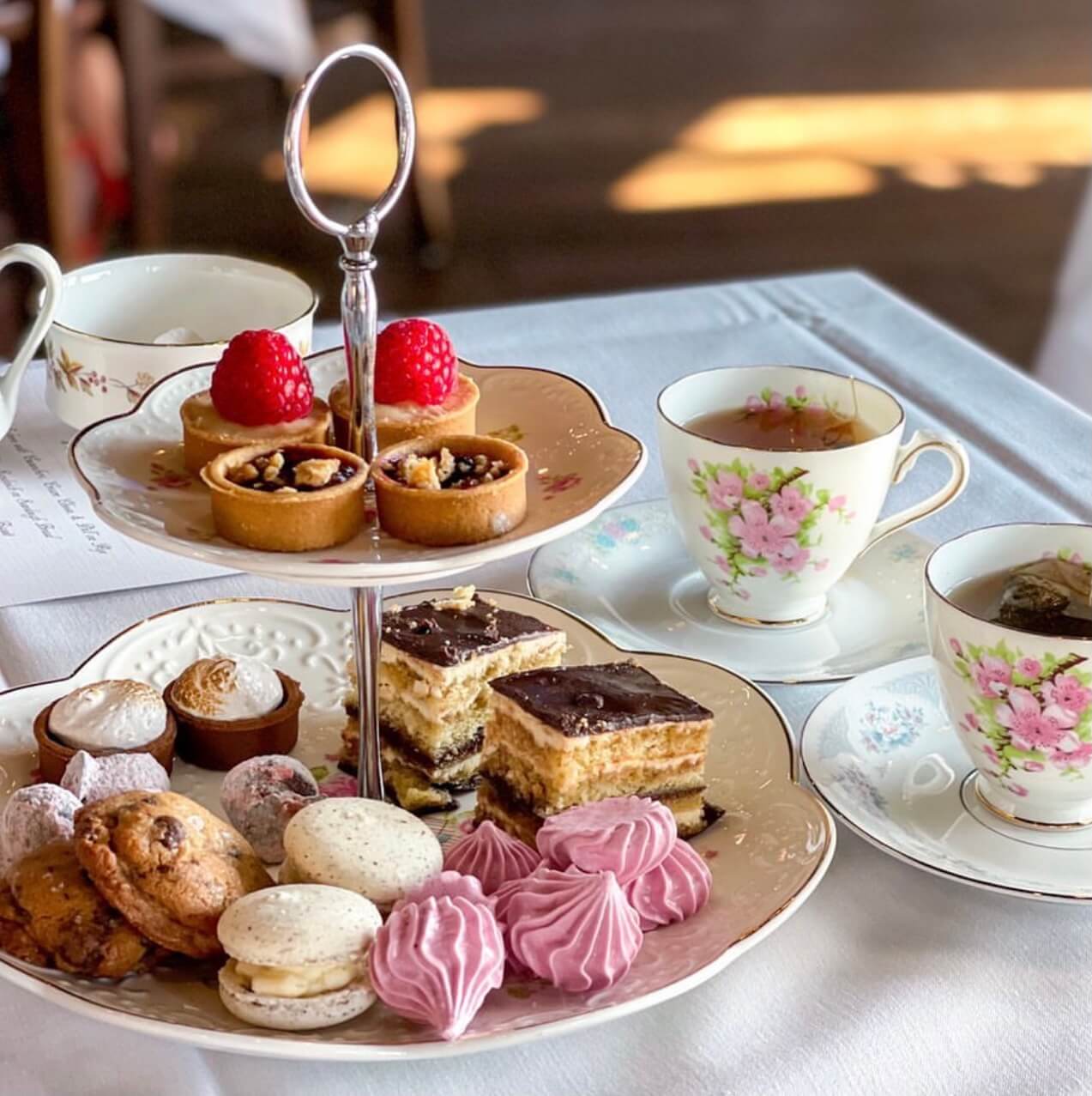 Dessert tray and cups of tea.