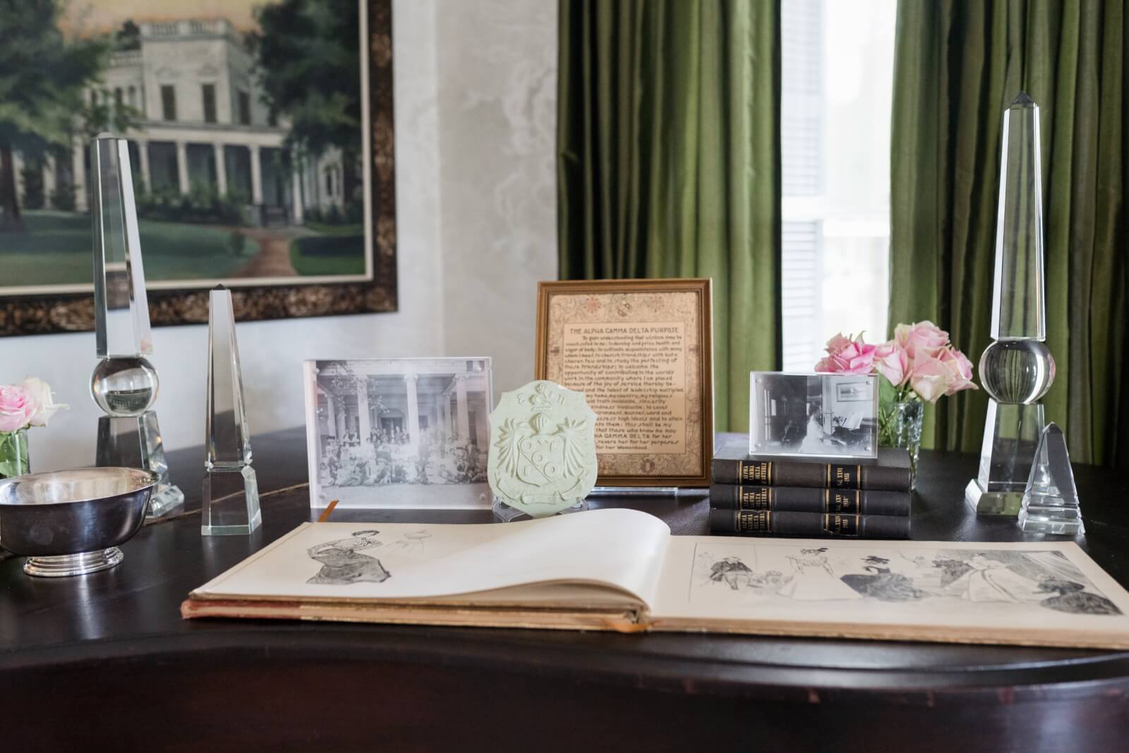 Close-up of a vignette that features books, photos, and a silver bowl