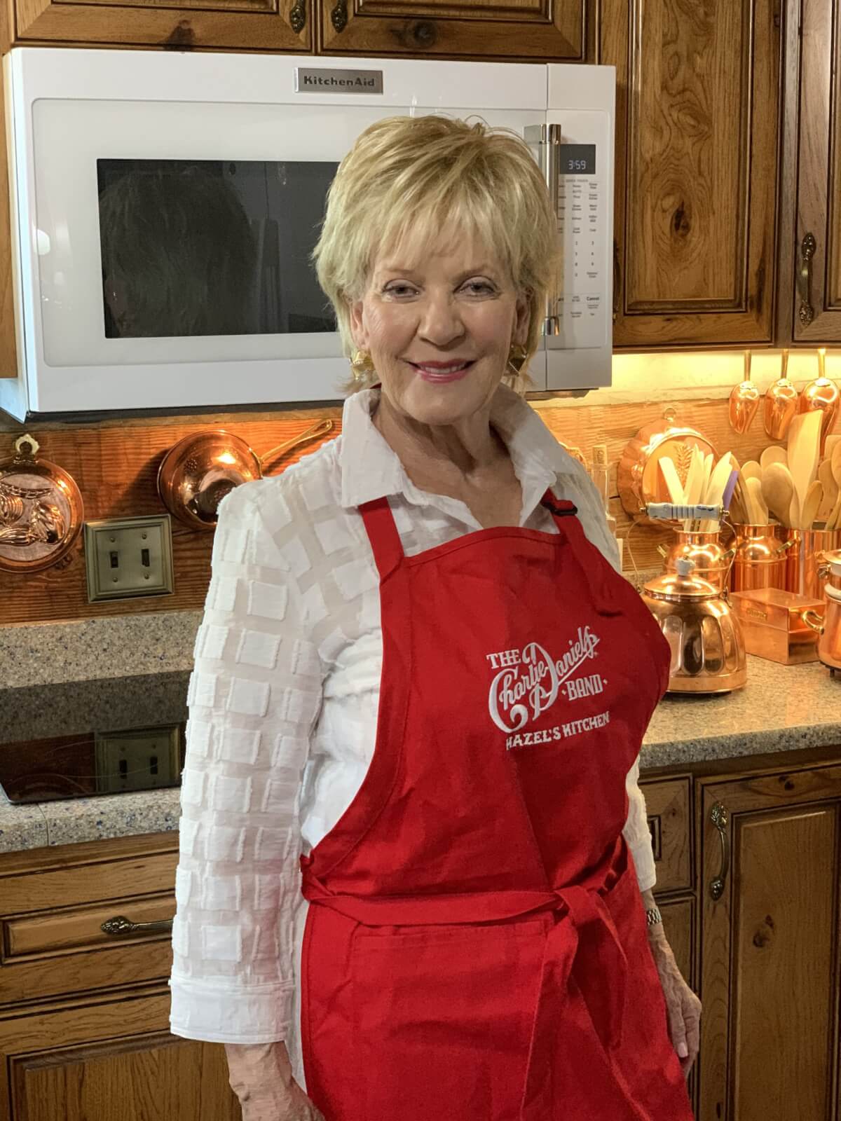 Hazel Daniels in a red apron in her kitchen.