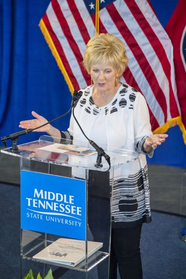 Hazel Daniels behind an MTSU podium, in front of a flag