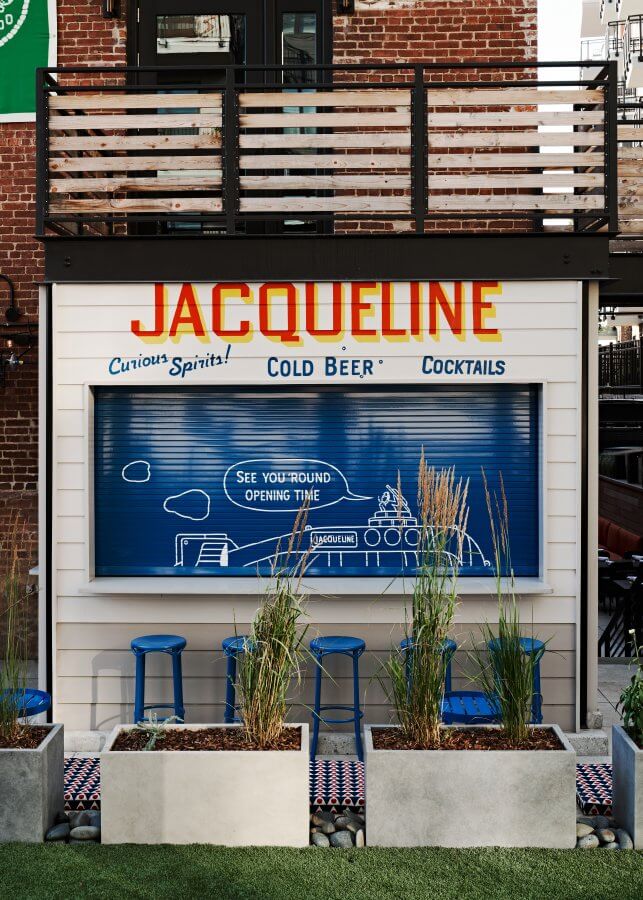 The Jacqueline walk-up featuring blue stools.