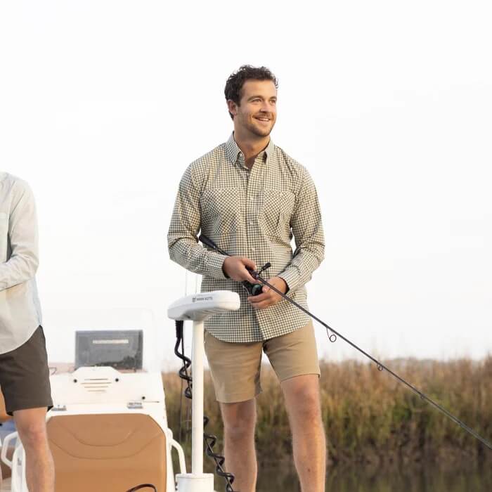 Man fishing in shorts and long sleeve shirt