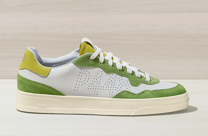 A green and white low-top sneaker, one of the best sneakers, displayed against a neutral background.
