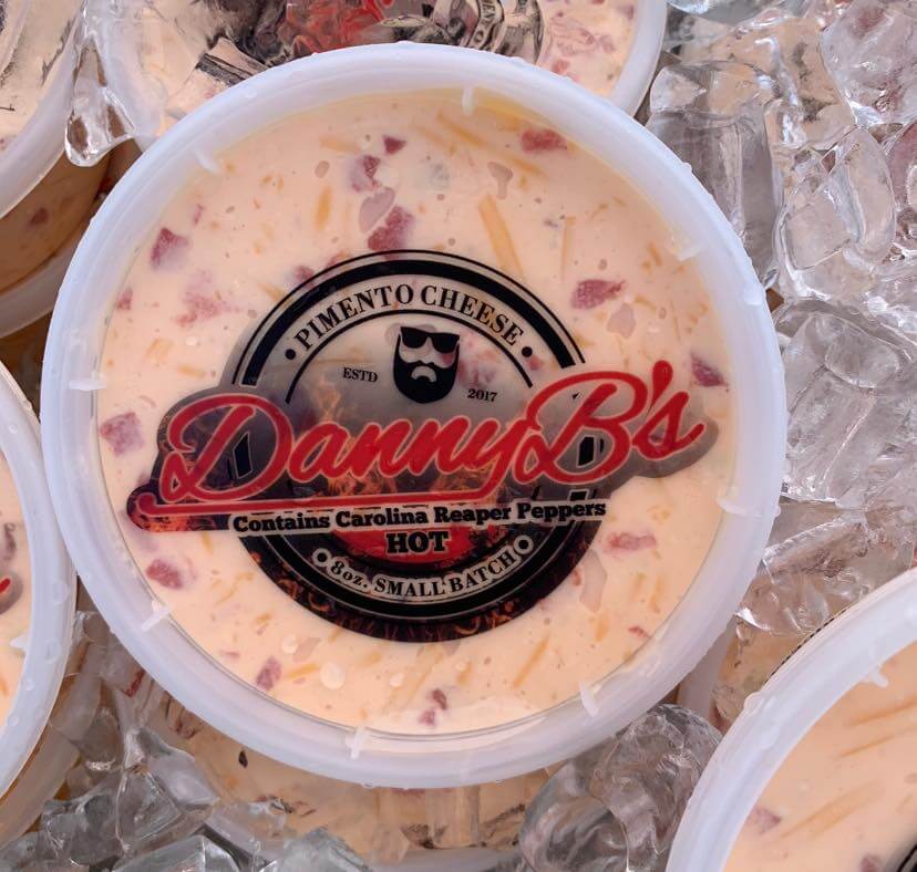 container of pimento cheese in cooler of ice