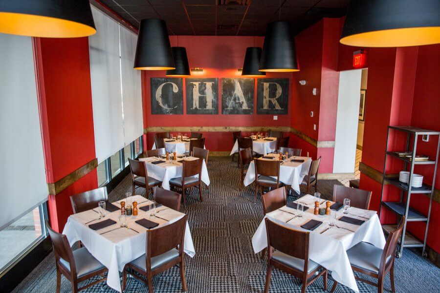 A red dining room and private event space at Char in Nashville.