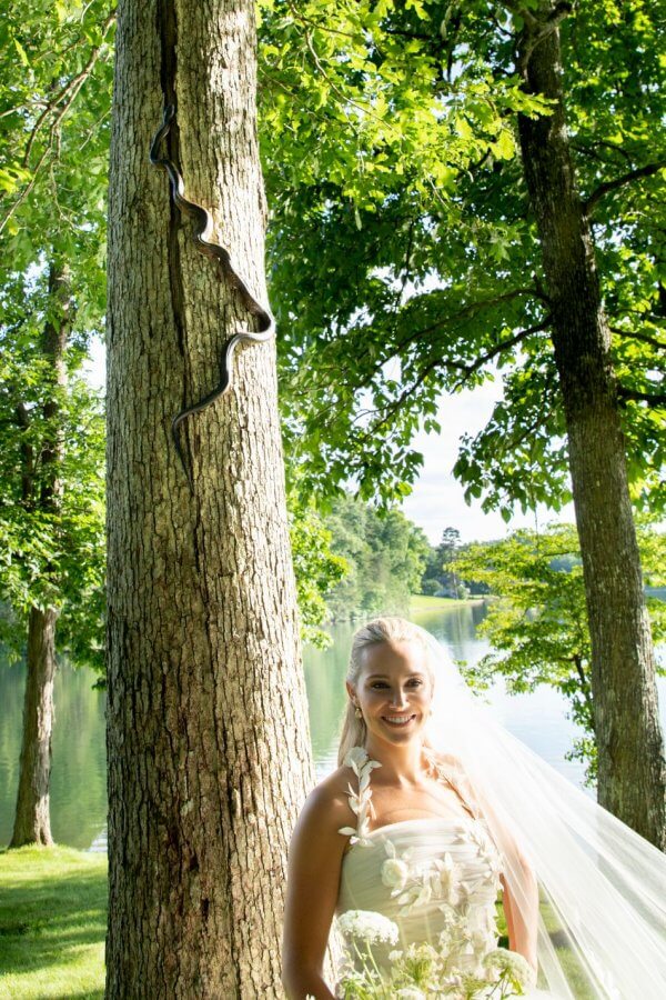 A Wild Storybook Wedding You Won't Believe - 10 Kimberlin poses with snake on tree