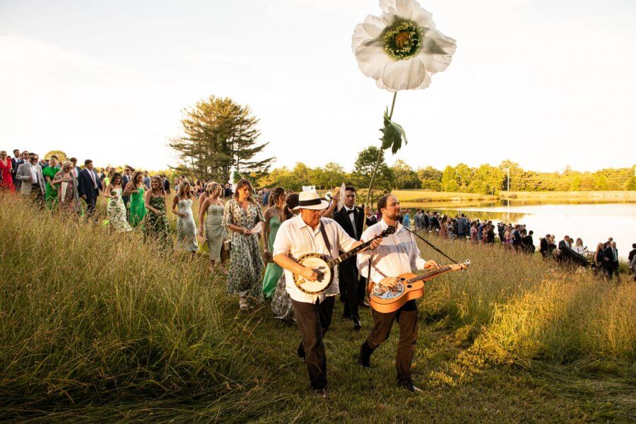 A Wild Storybook Wedding You Won't Believe - 16 Wedding party walks in sunset to the cocktail hour