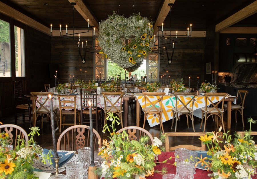 A Wild Storybook Wedding You Won't Believe - 6 Rehearsal dinner barn party spread with giant flower heart above