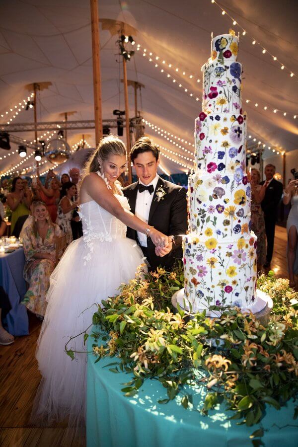 A Wild Storybook Wedding You Won't Believe - 23 Bride and groom with giant colorful cake