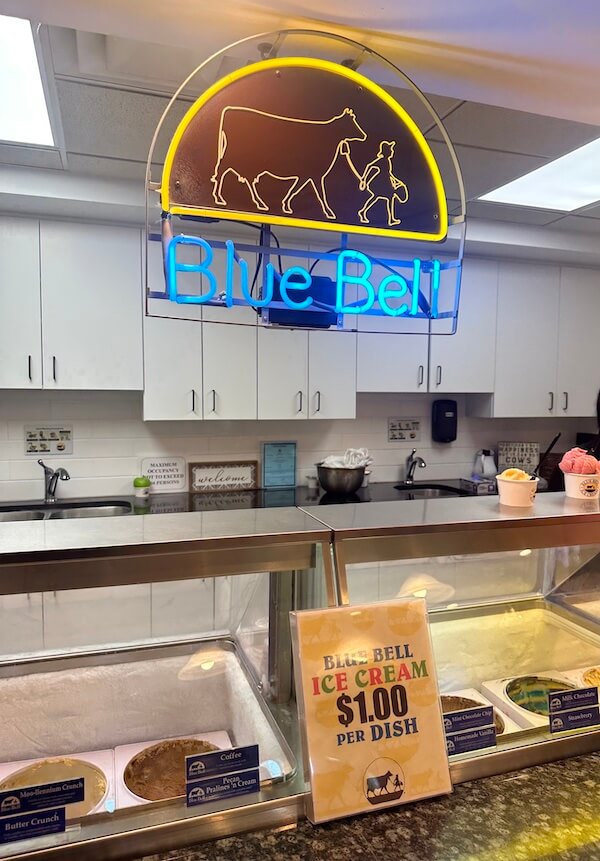 Blue Bell neon sign over ice cream counter