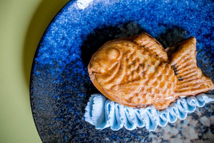 Fish-shaped puff pastry on blue plate.