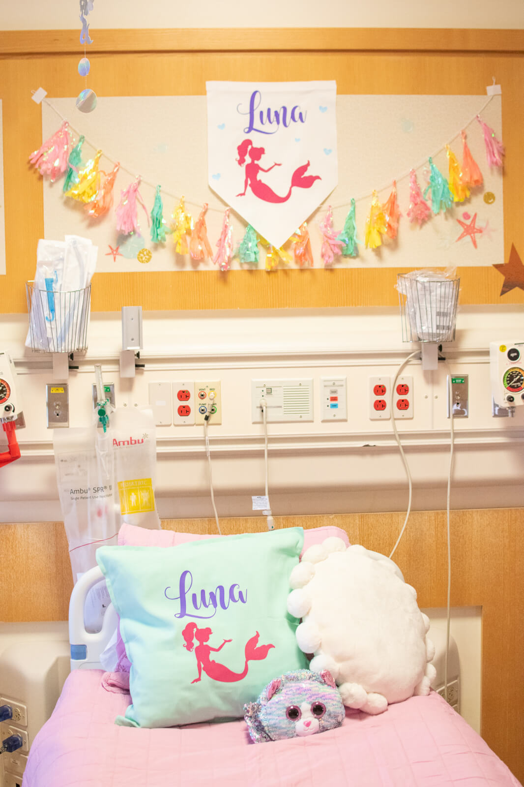 Children's hospital bed with colorful banner above the bed.