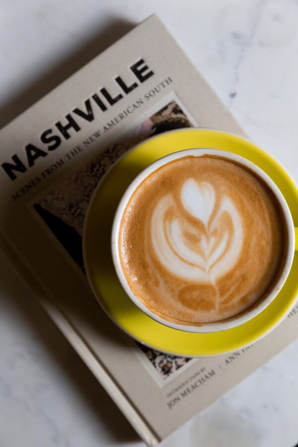 Coffee cup with yellow saucer on a Nashville book