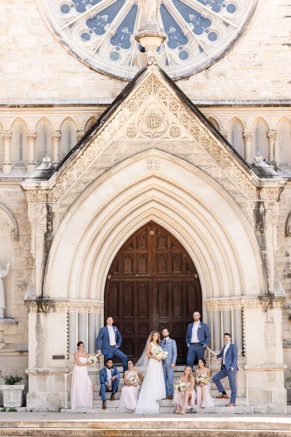 Bride and groom photos on the steps of a Cathoilic church
