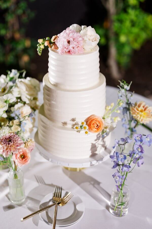 White cream wedding cake with pastel colors