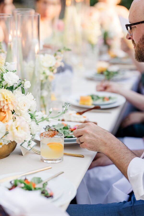 Person eating wedding seated dinner with margarita