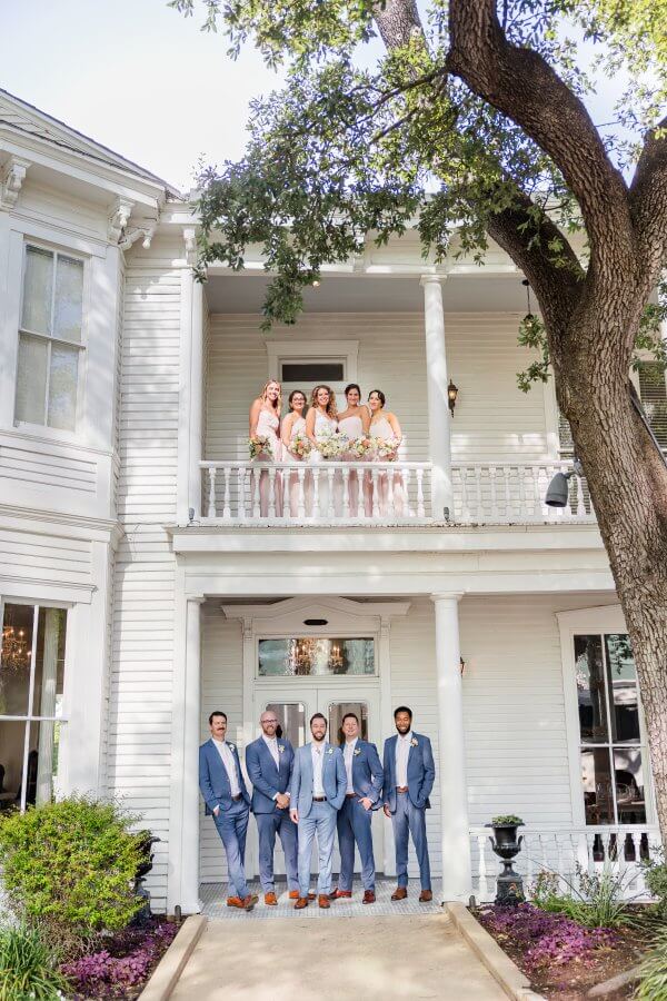 wedding party up on a balcony and down on a porch
