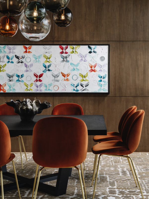Close-up of dining room table with orange chairs