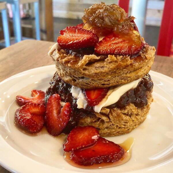 A decadent biscuit covered in strawberries, fennel marmalade, vanilla mascarpone, and berry jam.