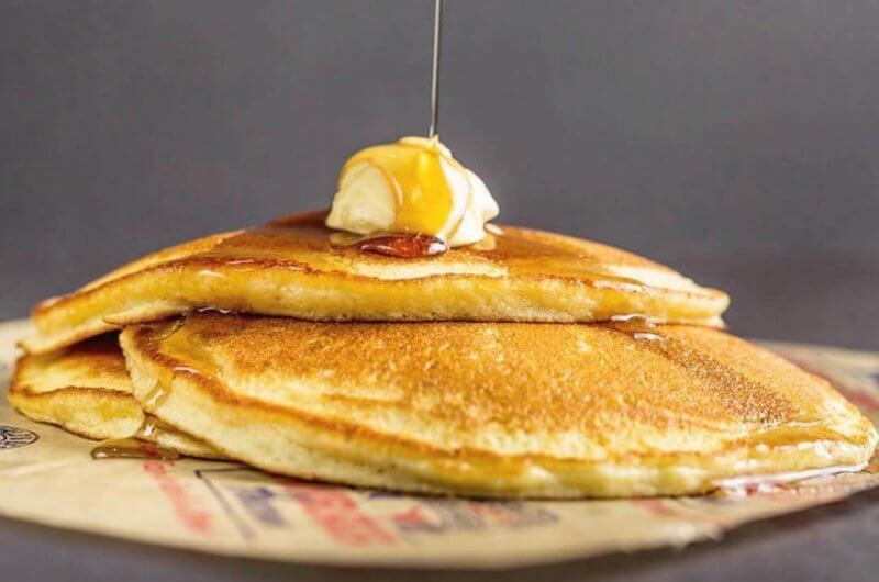 Heavenly Hamburger's stacked pancakes topped with butter and syrup.