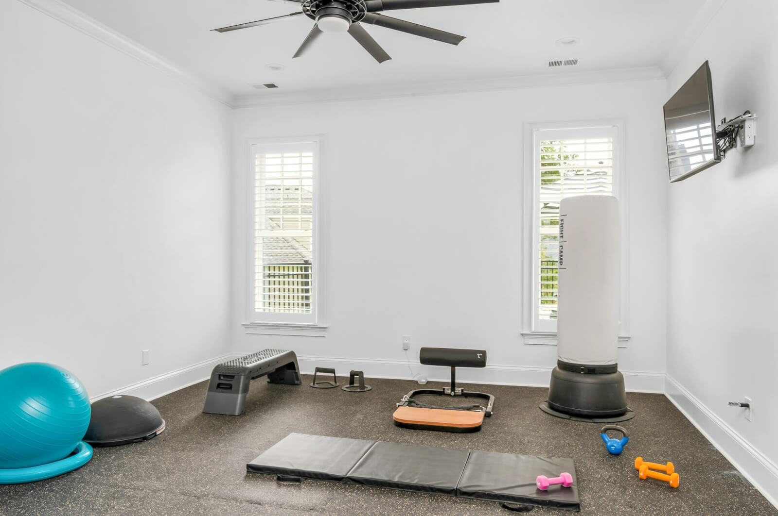Home gym with exercise equipment on the floor. 