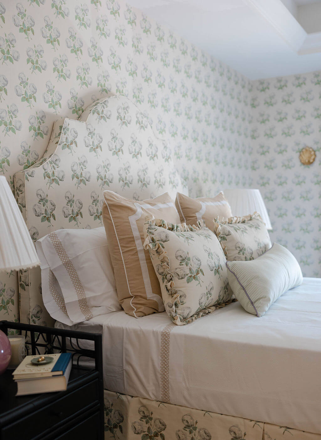 Guest bedroom with matching floral print on wall and bed headboard
