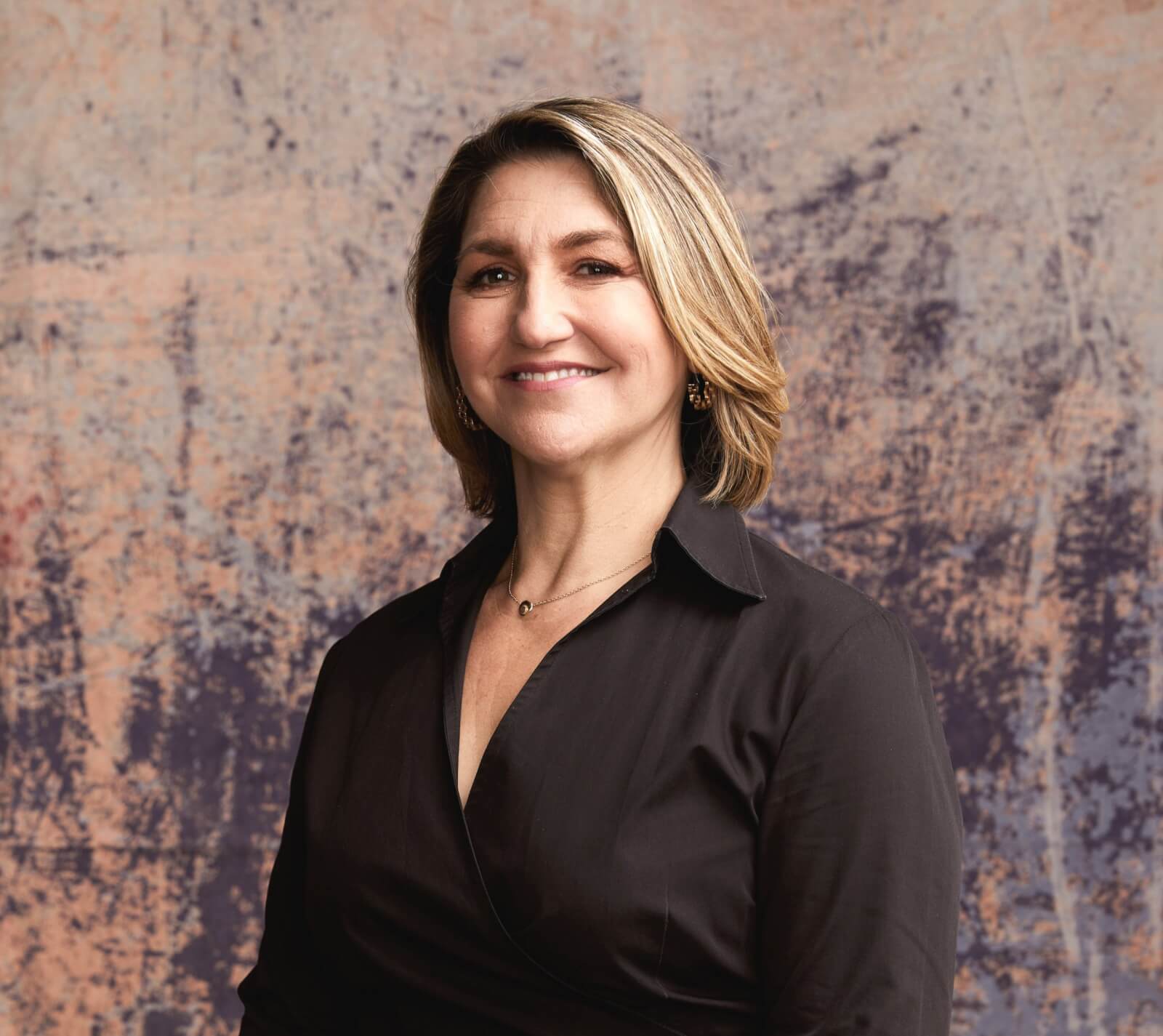 Woman in black blouse against artistic background