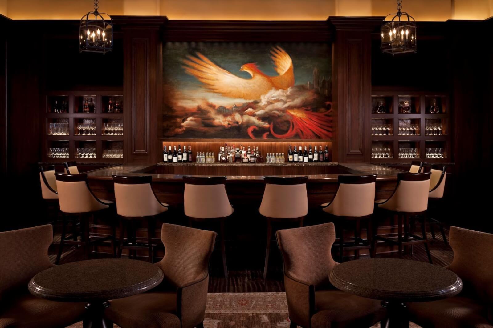 Dark bar area with mural of a bird.