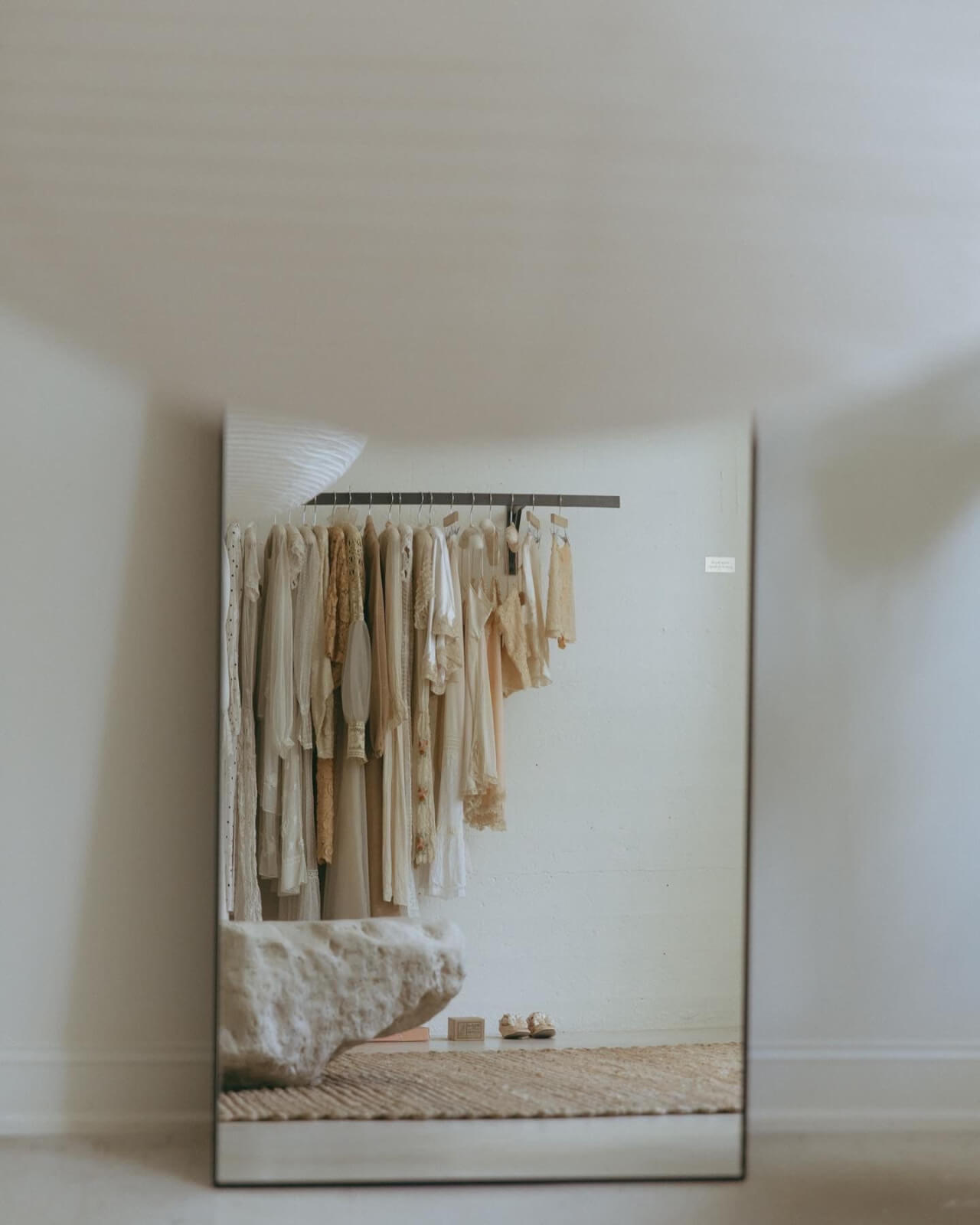 A mirror reflects Devore's vintage clothing selection.