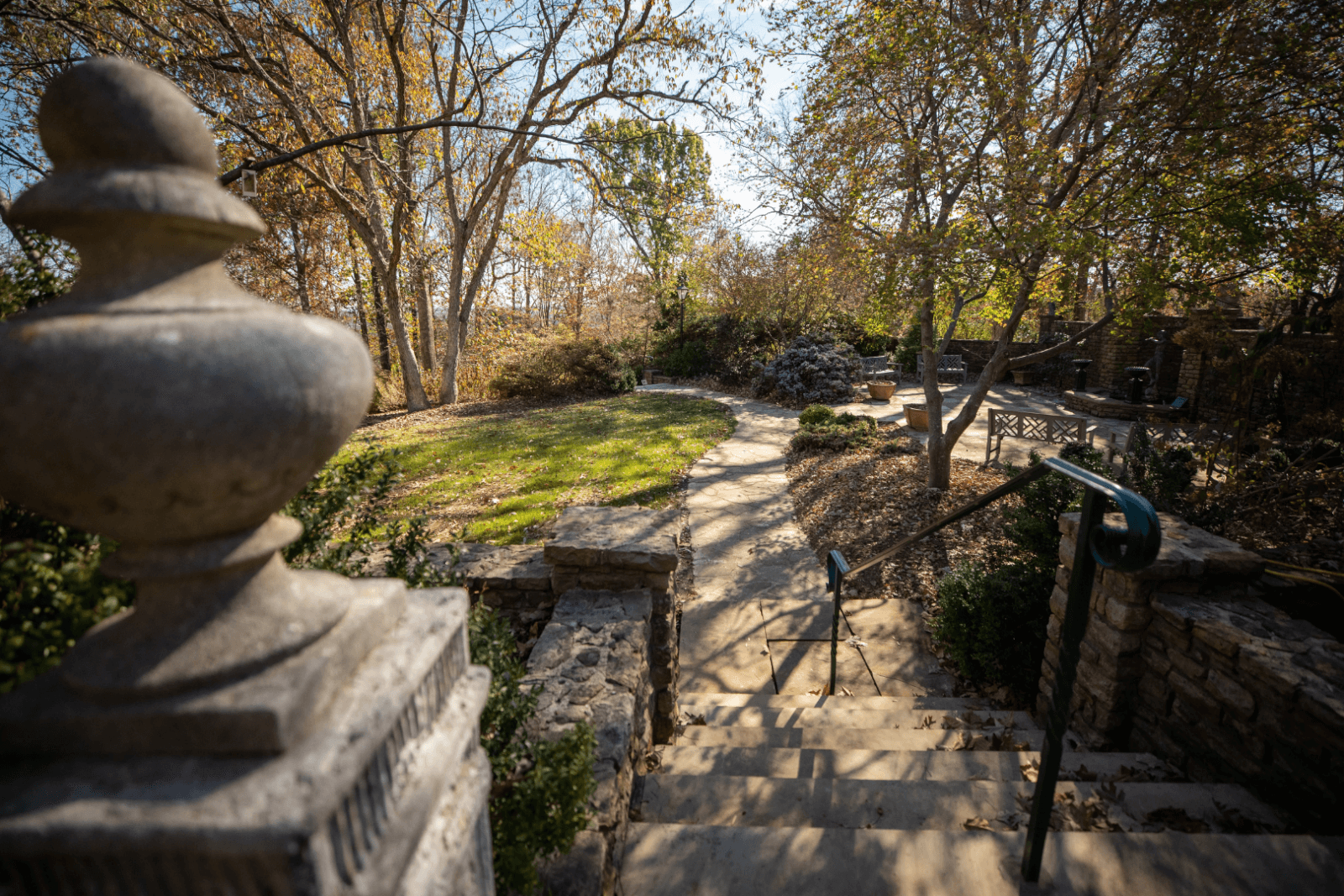 Stone steps leading to a walking path and garden.