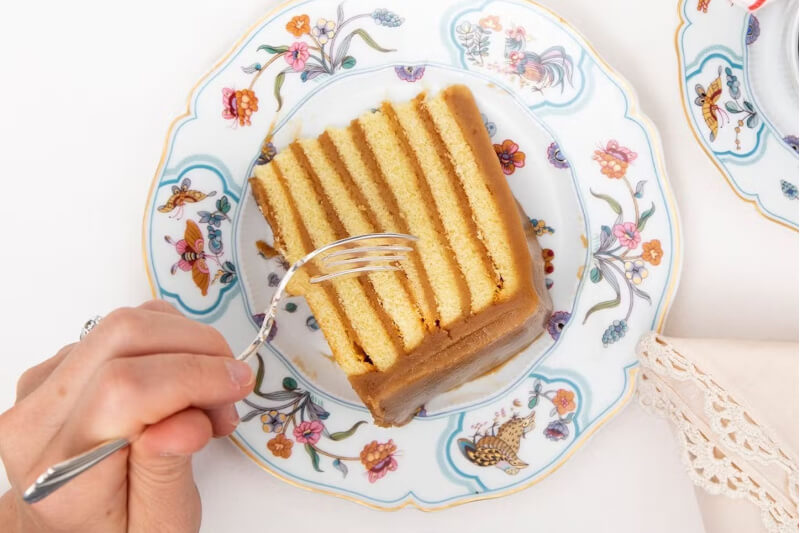 caramel cake on a plate with a fork
