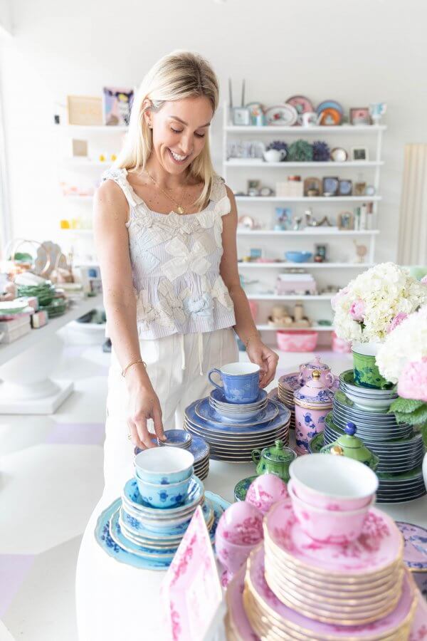 Kwynn Everest owner of Odd McLean standing in the store near shelves of colorful products.