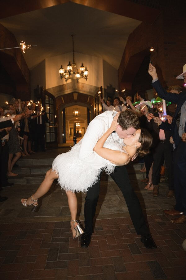 Groom dipping bride as they exit