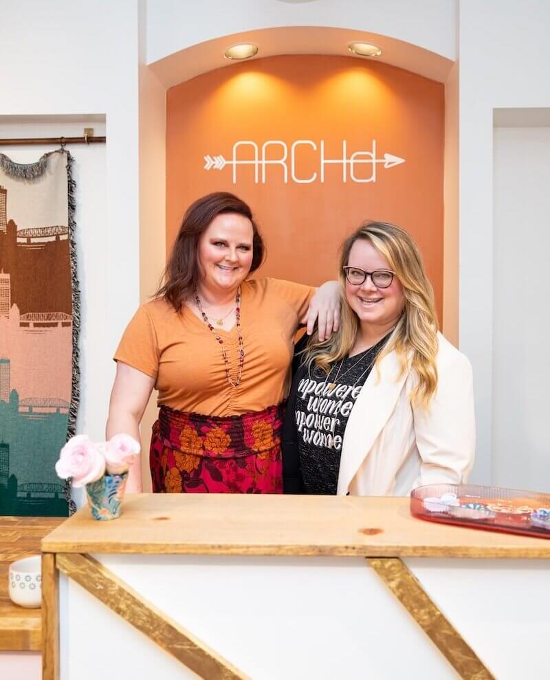 two women posing in retail shop