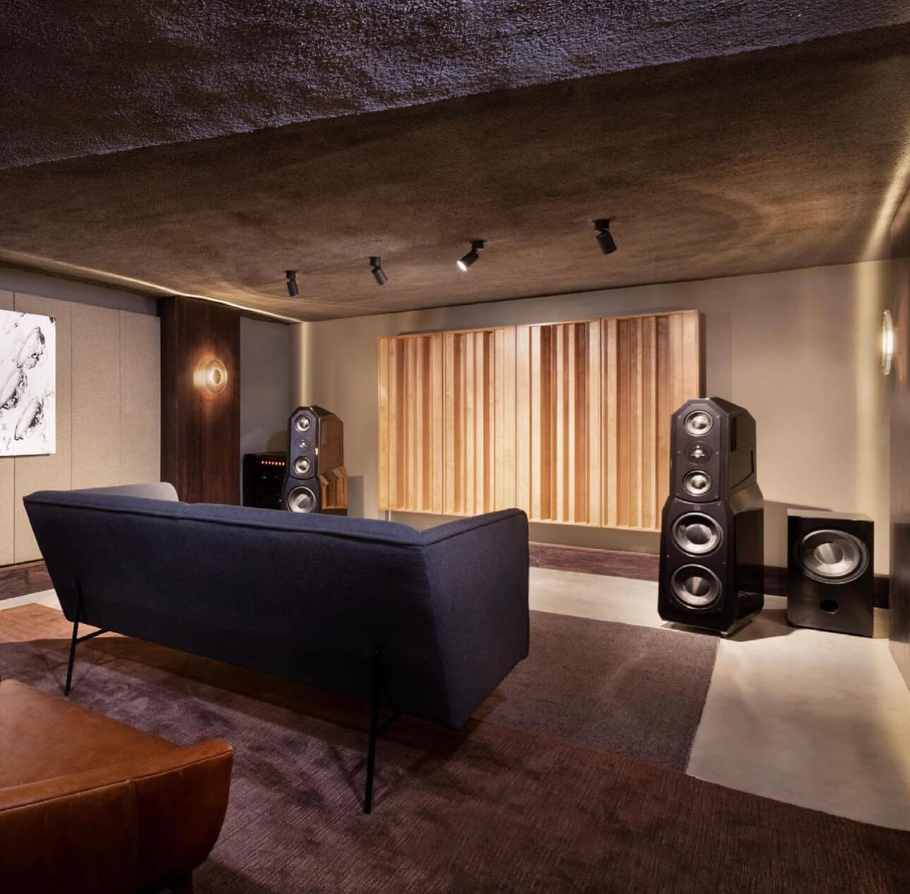 Listening room with speakers and blue couch