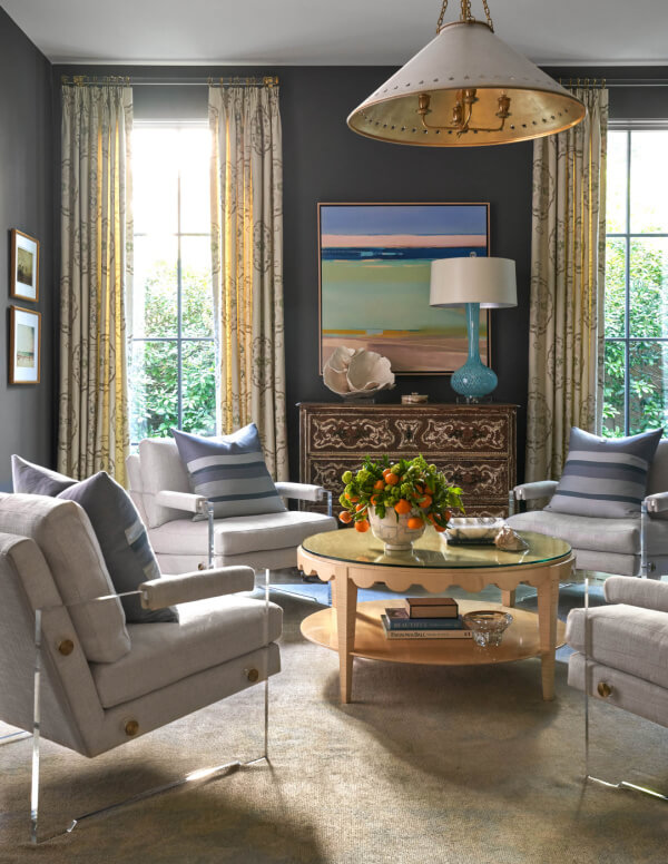 Moody living room with seating area surrounding round coffee table