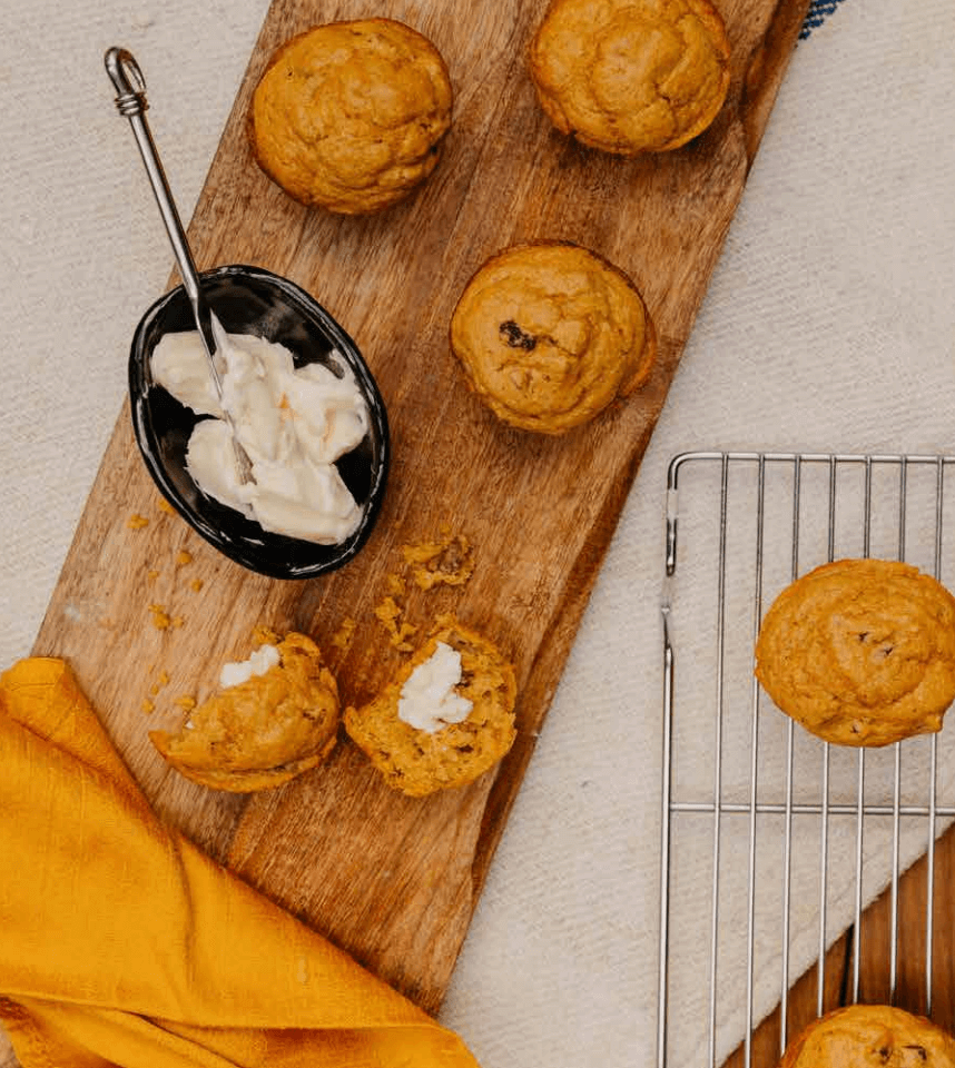 pumpkin muffins on a board with butter