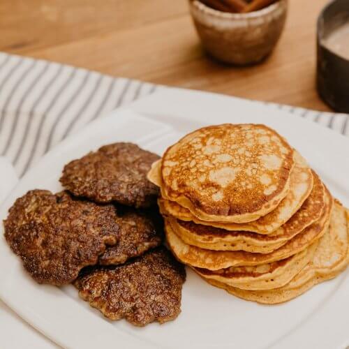 Plate of pancakes with sausage patties