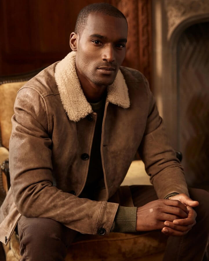 man in leather jacket looking at camera with hands crossed